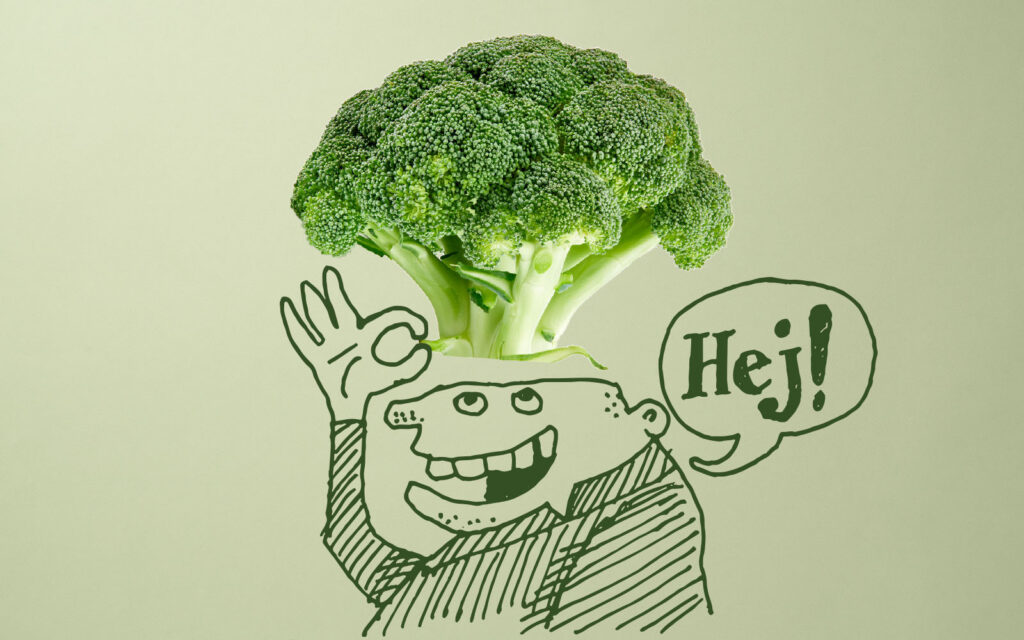 Tecknad figur som lyfter på en hatt gjord av en broccolikvist, samtidigt som han säger hej.